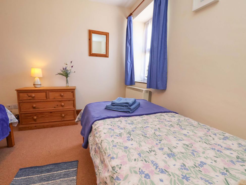 A bedroom with two beds and a lamp at 4 Cliff Cottages Port Mulgrave near Staithes