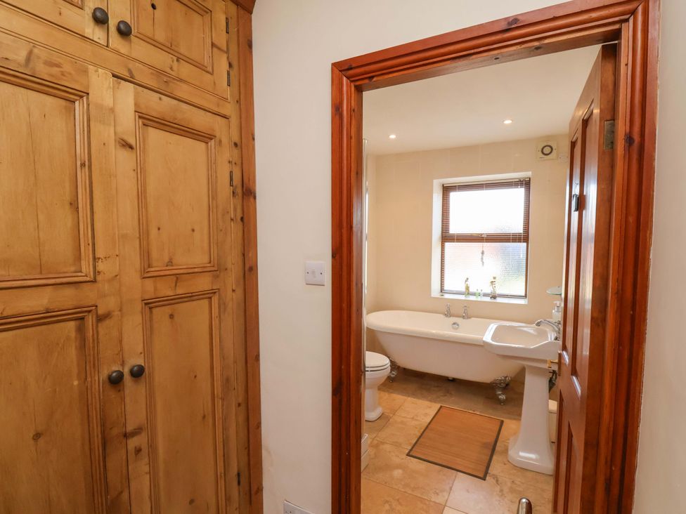 A bathroom with a bath tub and sink at 4 Cliff Cottages Port Mulgrave near Staithes
