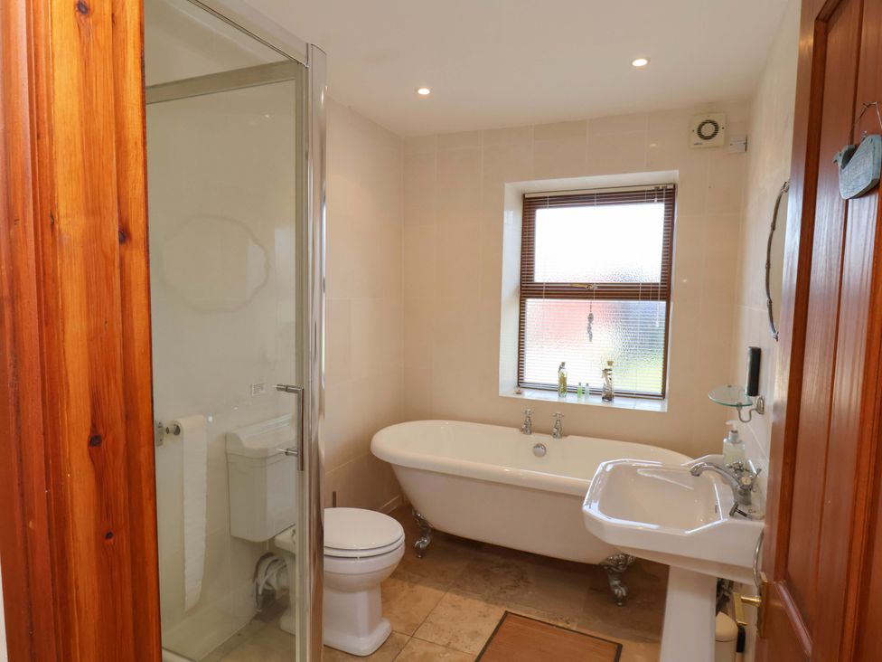 A bathroom with a bathtub, toilet, and sink at 4 Cliff Cottages Port Mulgrave near Staithes