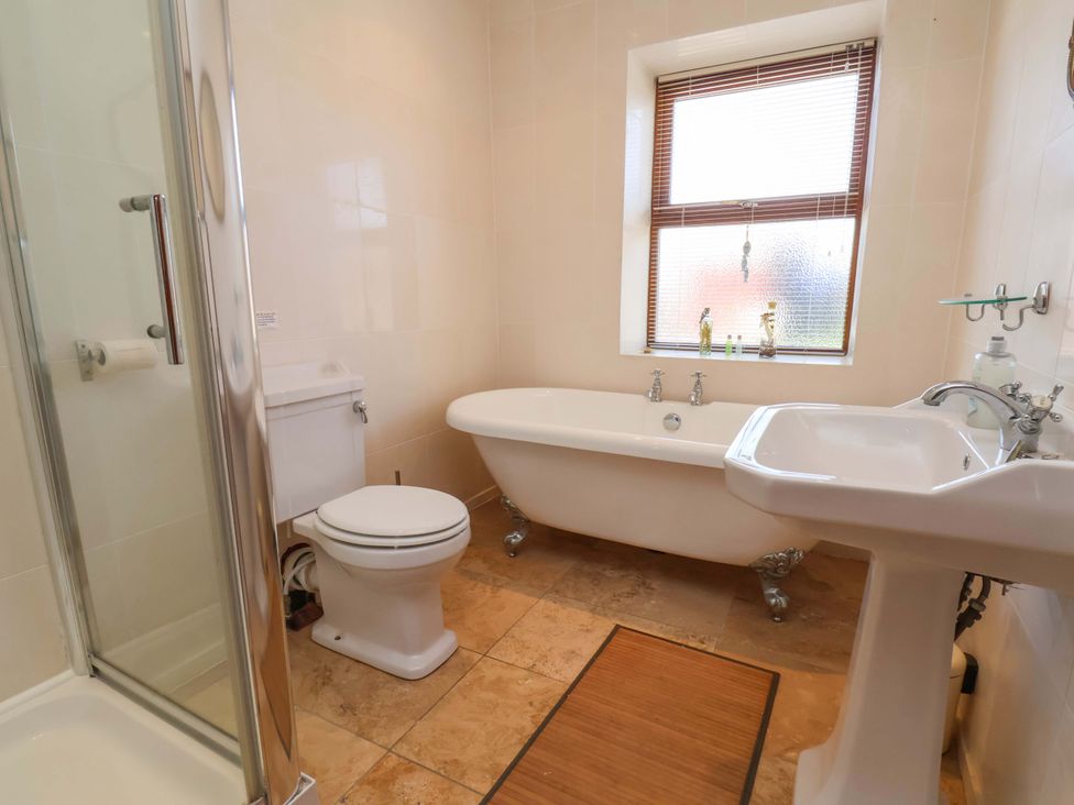 A bathroom with a bathtub, toilet, and sink at 4 Cliff Cottages in Port Mulgrave near Staithes