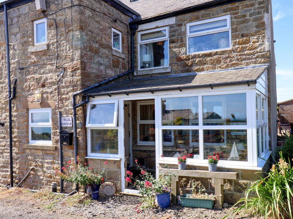 A house exterior with a sign and plants at 4 Cliff Cottages Port Mulgrave near Staithes