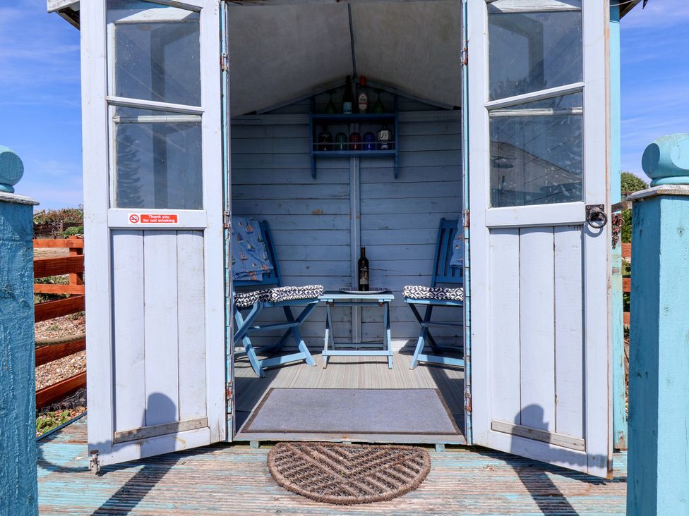 An outdoor seating area with chairs and a table at 4 Cliff Cottages in Port Mulgrave near Staithes