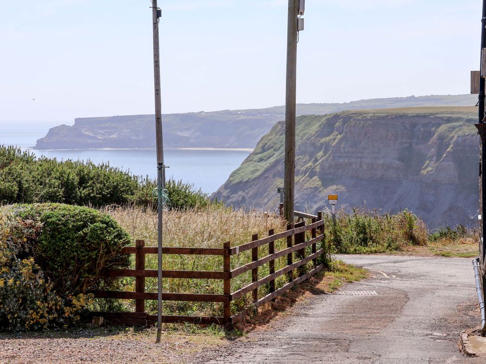 A coastal scene with cliffs and ocean at 4 Cliff Cottages Port Mulgrave near Staithes