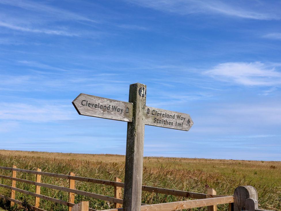 A signpost indicating Cleveland Way and Staithes near a pathway