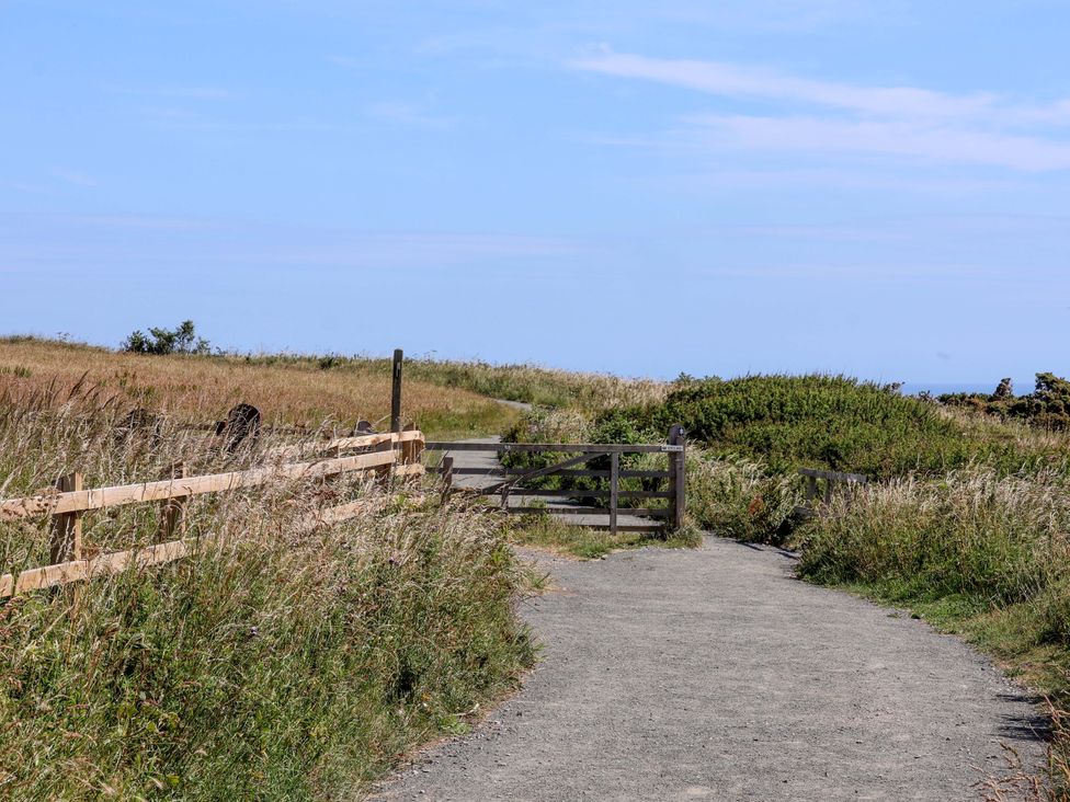 A path leading to a gate with a fence and grass at 4 Cliff Cottages Port Mulgrave near Staithes