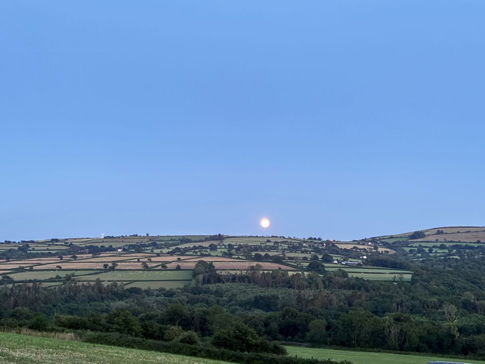 A landscape with fields, hills, trees and the moon at Ysgubor - The Barn Boncath near Crymych