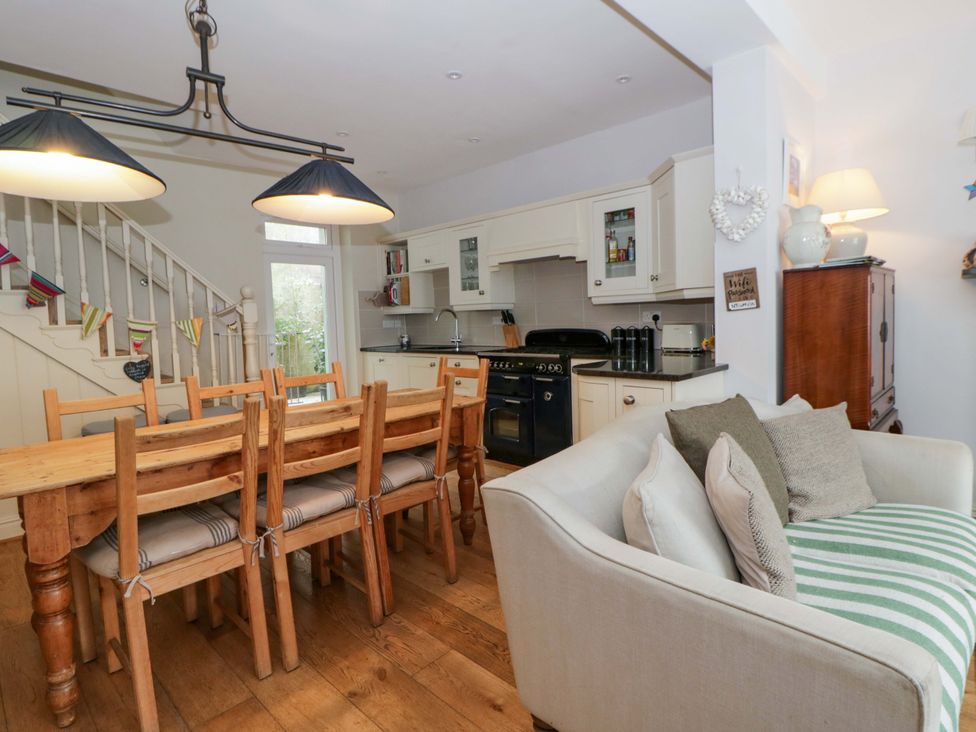 A kitchen with dining table and chairs at Rose Cottage in St Dogmaels near Cardigan