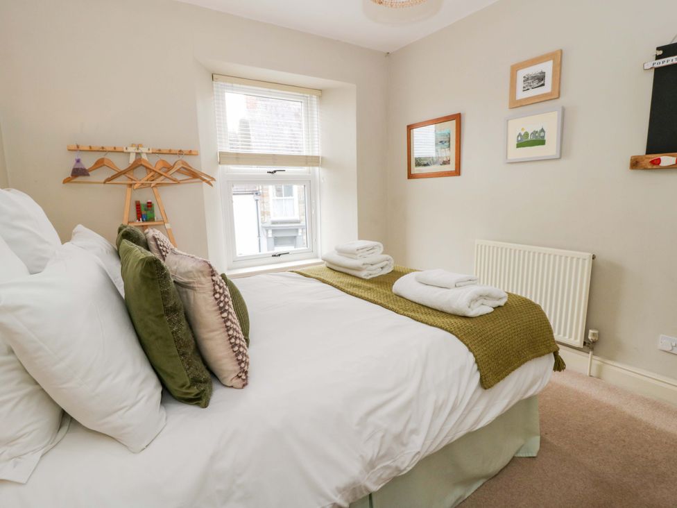A bedroom with a bed and wall art at Rose Cottage St Dogmaels near Cardigan