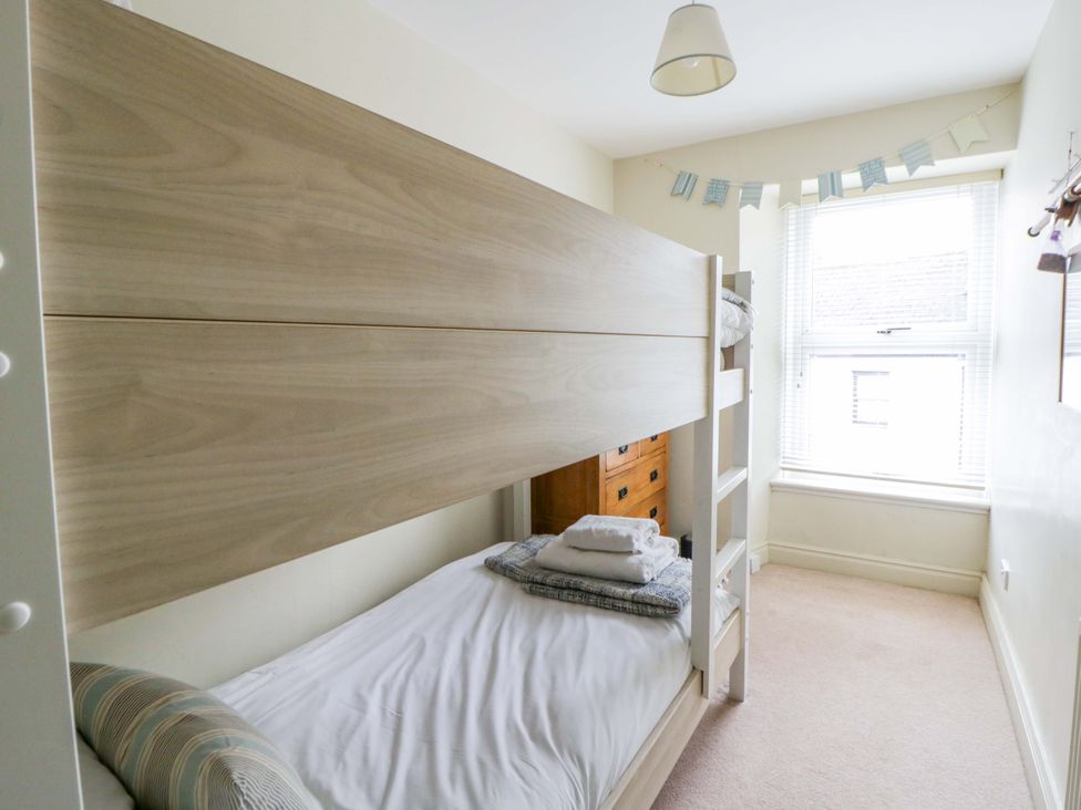 A bedroom with a bunk bed and a window at Rose Cottage St Dogmaels near Cardigan