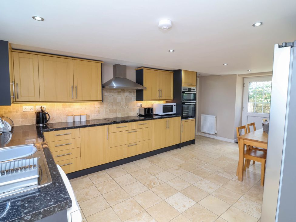 A kitchen with cabinets and appliances at Old Chapel in Clovelly