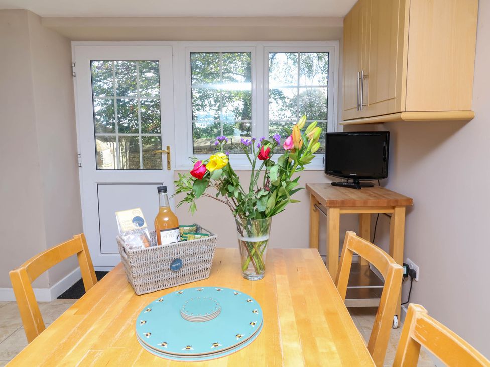 A dining room with a table and chairs at The Old Chapel in Clovelly