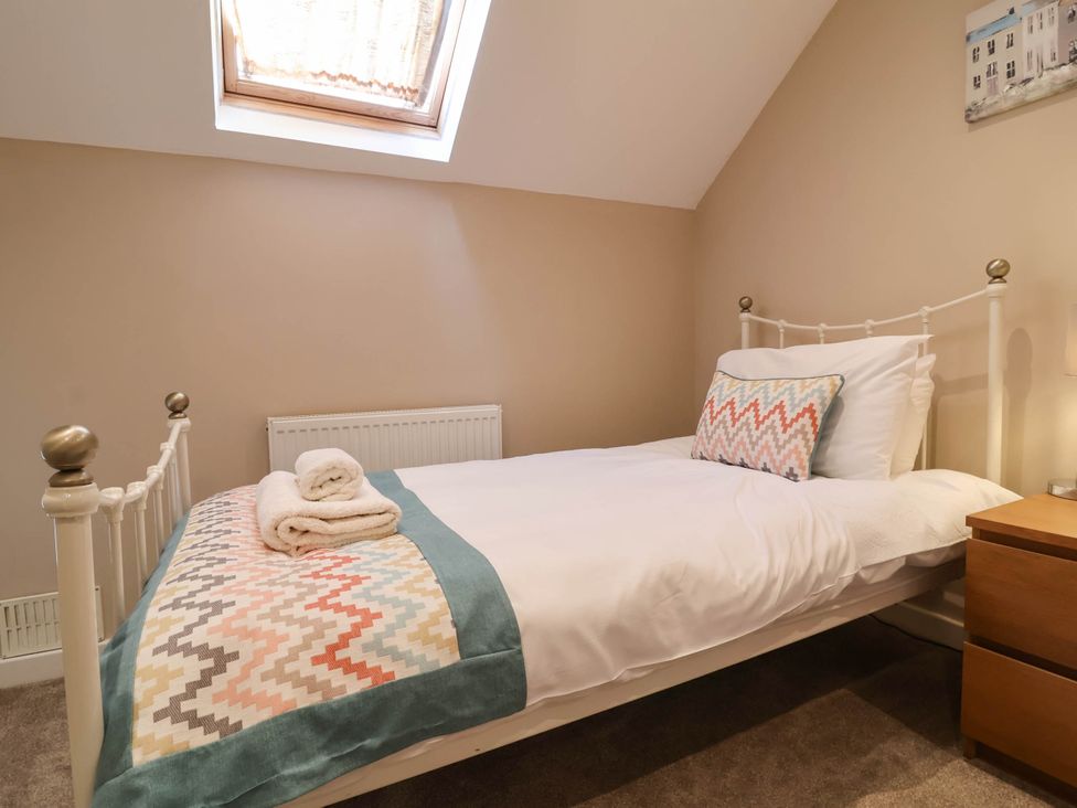 A bedroom with a bed and nightstand at Old Chapel in Clovelly