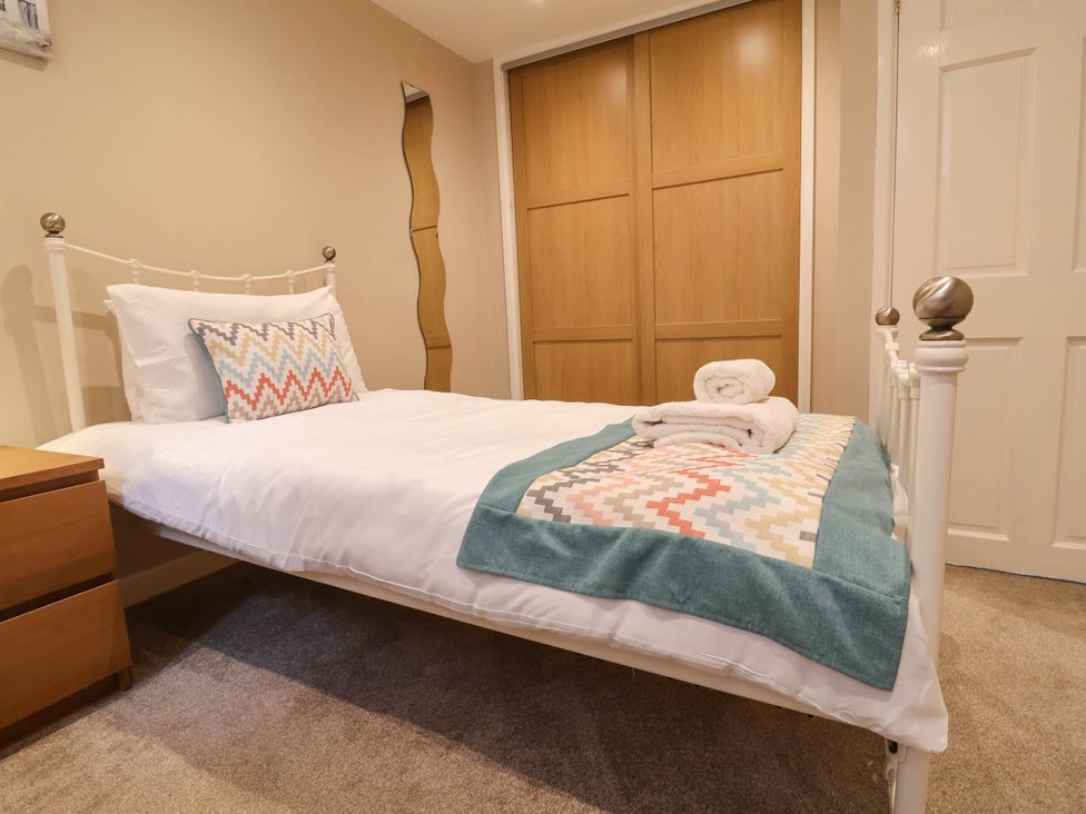 A bedroom with a bed and wardrobe at The Old Chapel in Clovelly