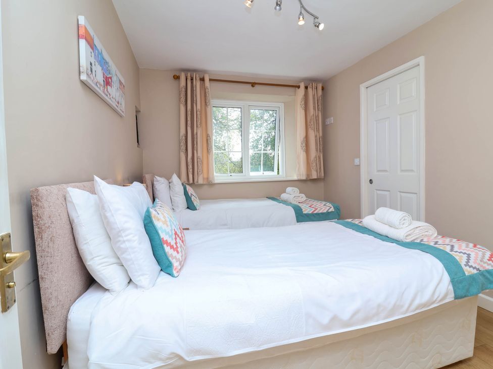 A bedroom with two beds and a window at The Old Chapel in Clovelly