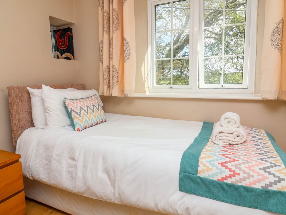 A bedroom with a bed and window at The Old Chapel in Clovelly