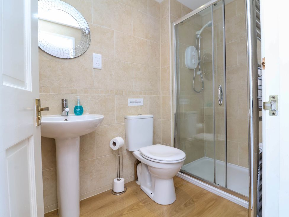 A bathroom with a sink, toilet, and shower at Old Chapel in Clovelly