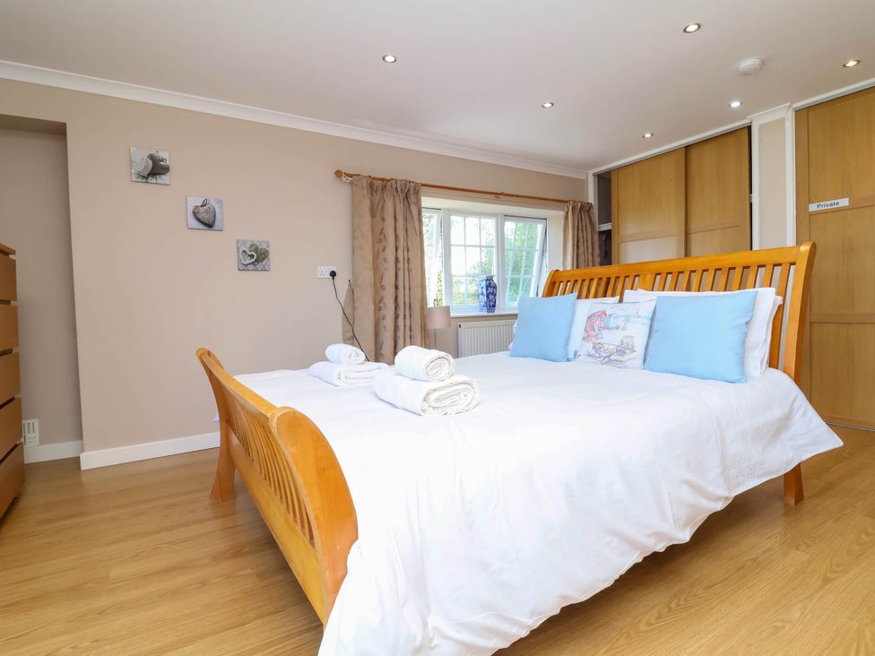 A bedroom with a bed and towels at The Old Chapel in Clovelly