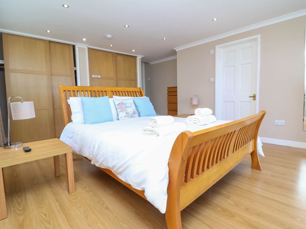A bedroom with a bed and bedside table at Old Chapel in Clovelly