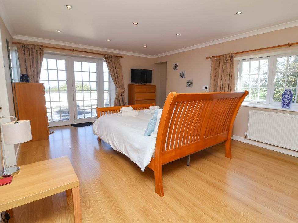 A bedroom with a double bed and a television at Old Chapel in Clovelly
