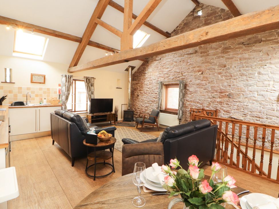 A living room with a couch and television at Stable Cottage in Bolton Low Houses