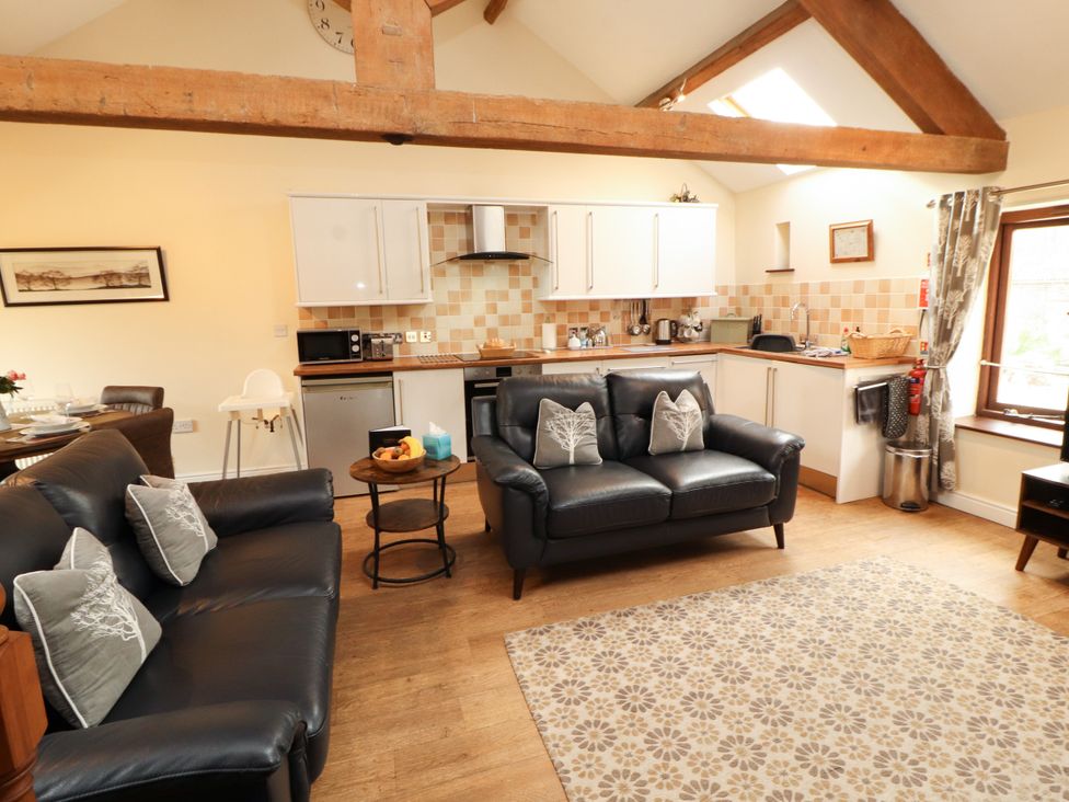 A living room with a kitchen area at Stable Cottage in Bolton Low Houses