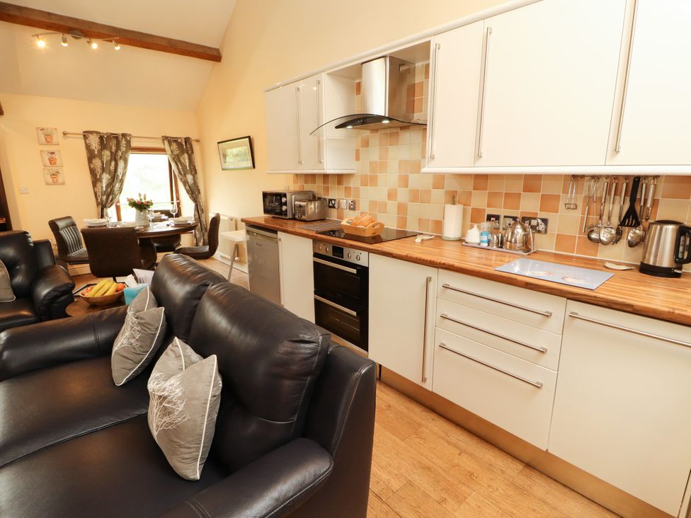 A kitchen with a dining area and seating at Stable Cottage Bolton Low Houses