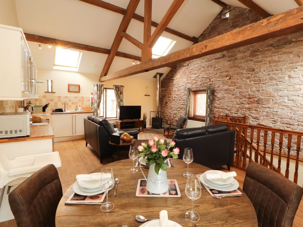 A living room with a kitchen area and dining space at Stable Cottage in Bolton Low Houses