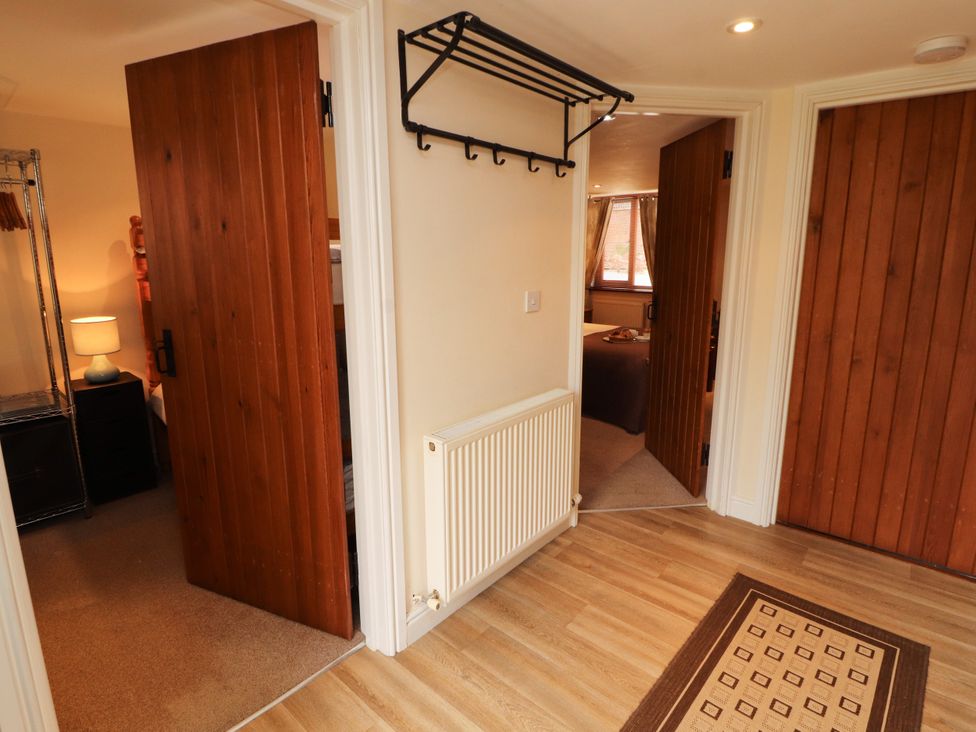 A hallway with doors and a coatrack at Stable Cottage in Bolton Low Houses