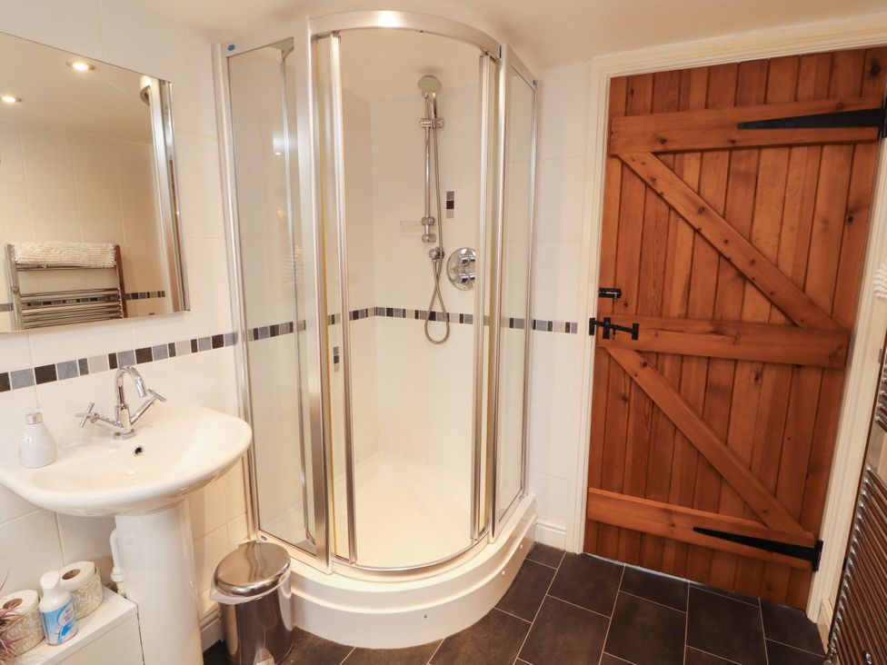 A bathroom with a shower and sink at Stable Cottage in Bolton Low Houses