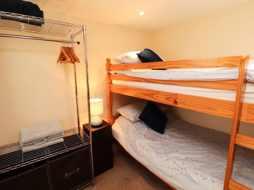 A bedroom with a bunk bed and shelving at Stable Cottage in Bolton Low Houses