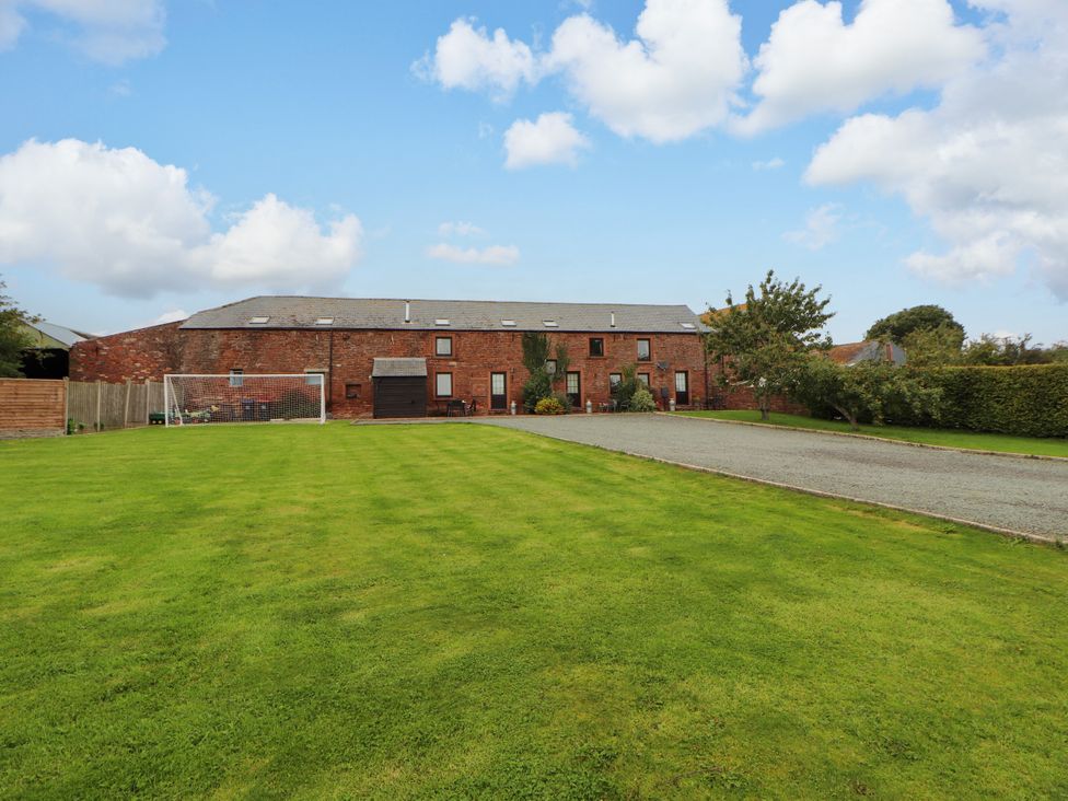 An outdoor view of a building with a goal and a grassy area at Stable Cottage in Bolton Low Houses
