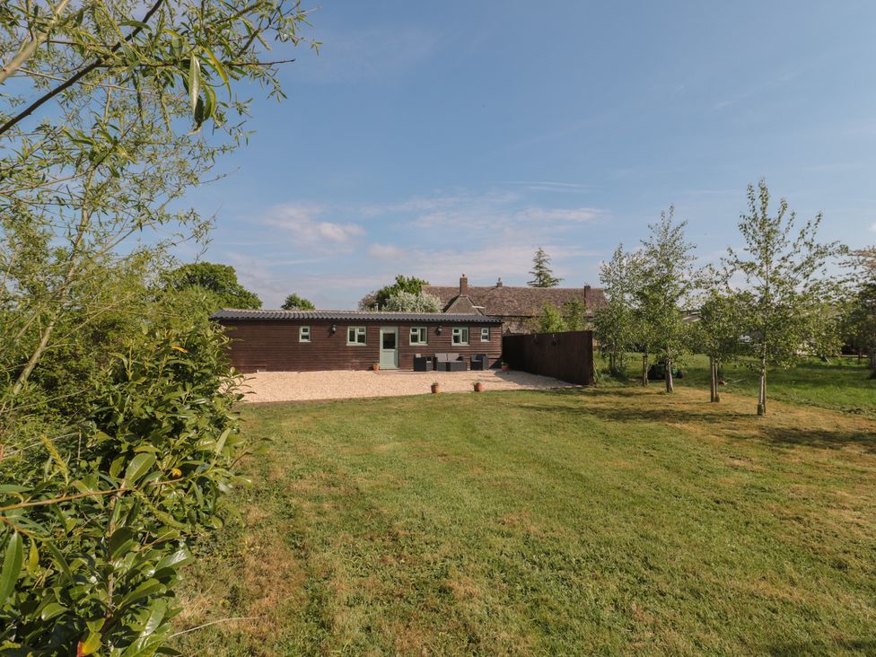 An outdoor view of a building with garden space at Garden Cottage, Rode Farm in Rode