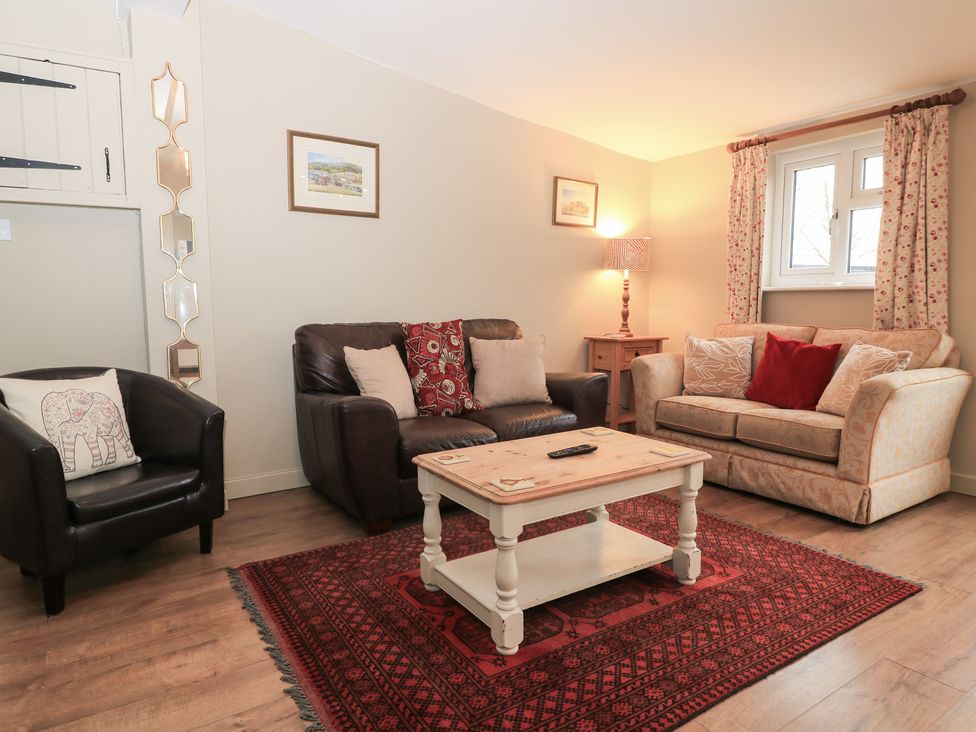 A living room with a sofa and coffee table at Garden Cottage, Rode Farm in Rode