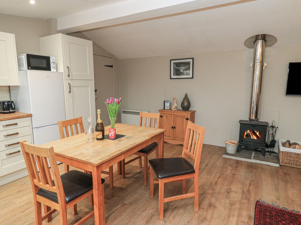 A dining room with a table and chairs at Garden Cottage, Rode Farm in Rode