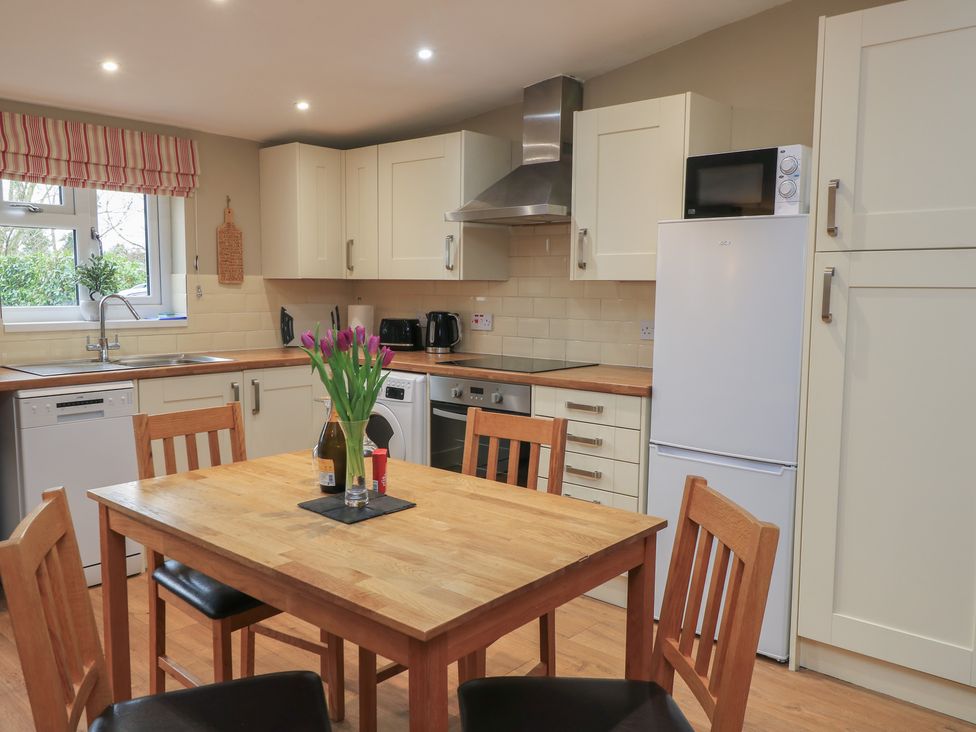 A kitchen with a table and chairs at Garden Cottage, Rode Farm, Rode