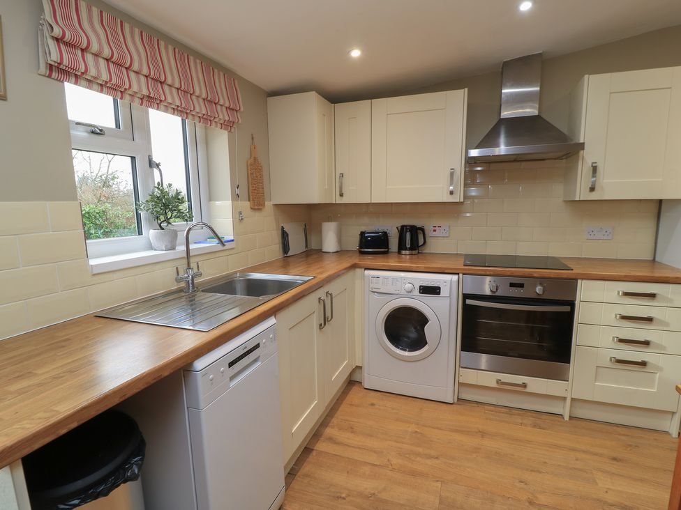A kitchen with appliances and cabinets at Garden Cottage, Rode Farm in Rode