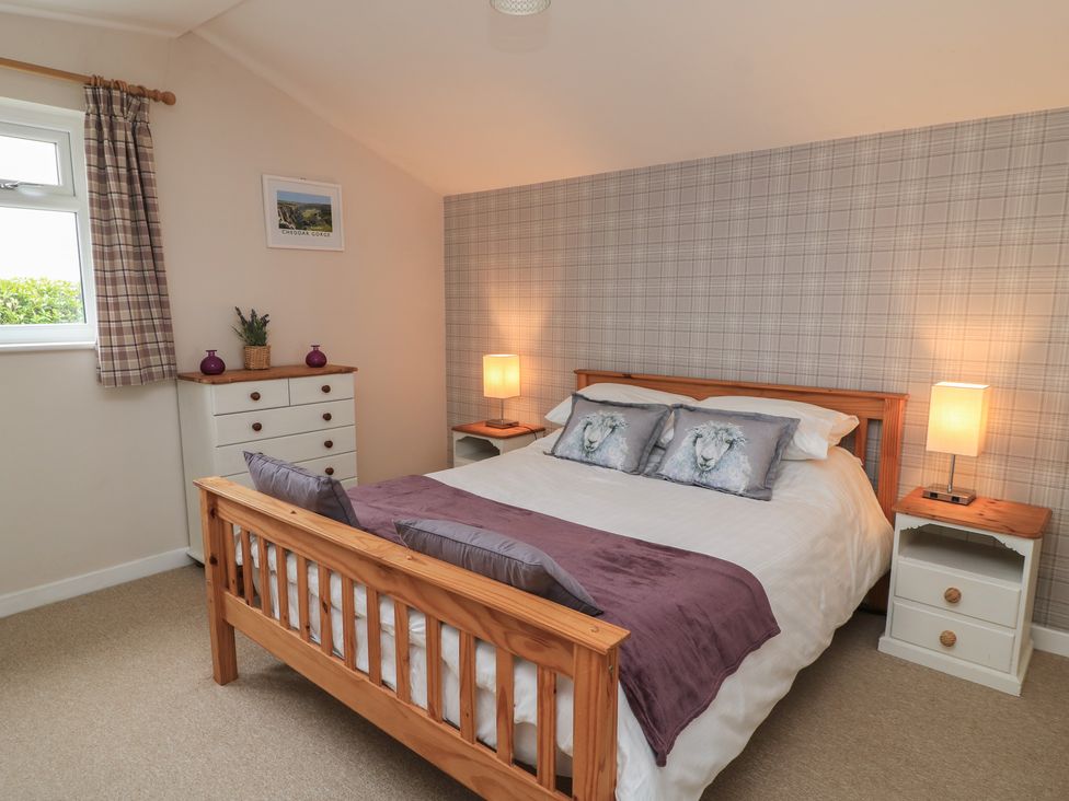 A bedroom with a bed and nightstands at Garden Cottage, Rode Farm in Rode