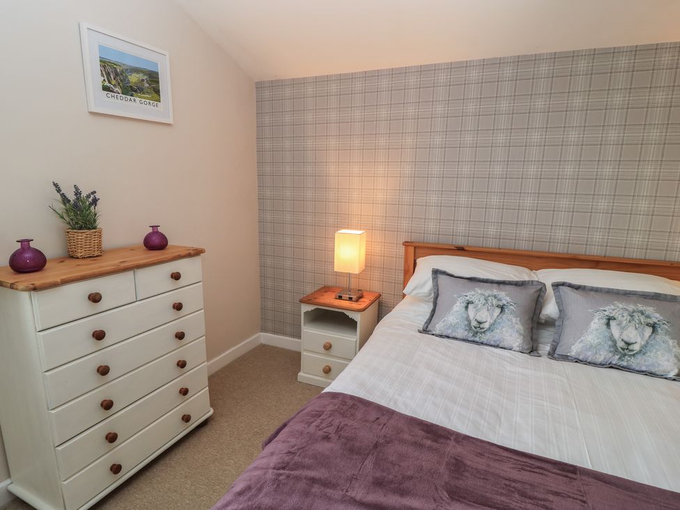 A bedroom with a bed and furniture at Garden Cottage, Rode Farm in Rode