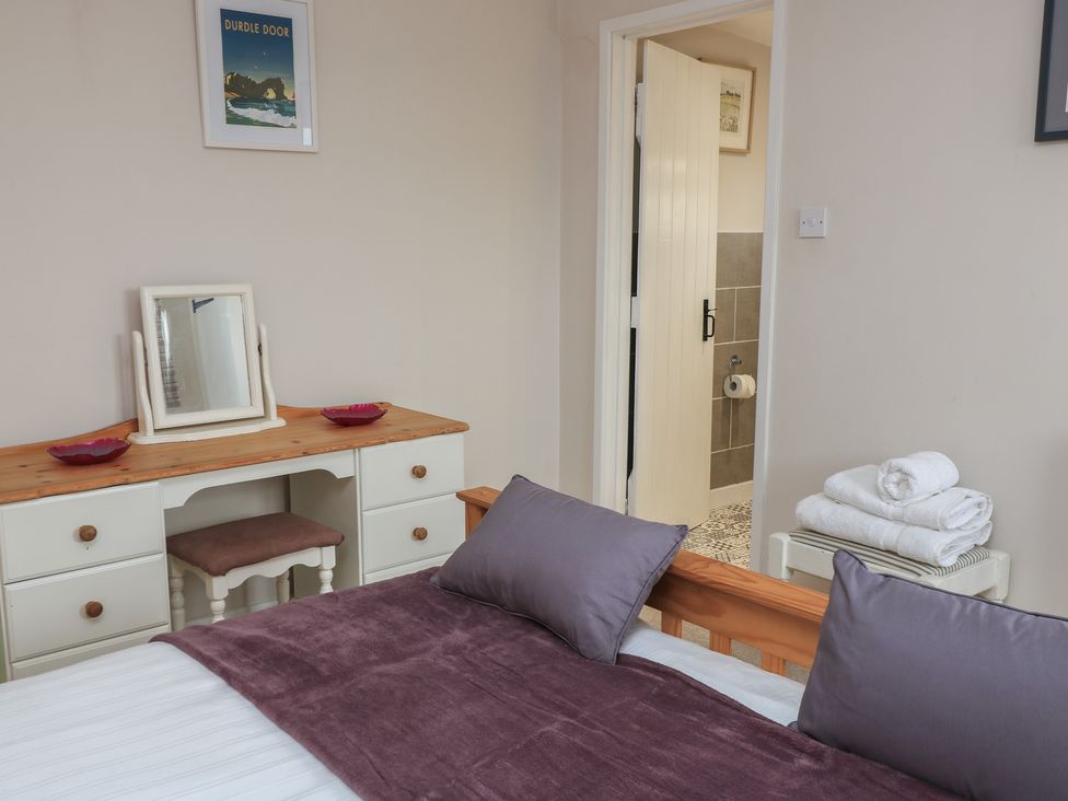 A bedroom with a bed and desk at Garden Cottage, Rode Farm in Rode