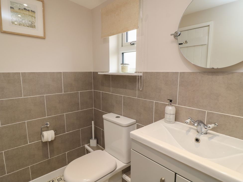 A bathroom with a toilet and sink at Garden Cottage, Rode Farm in Rode