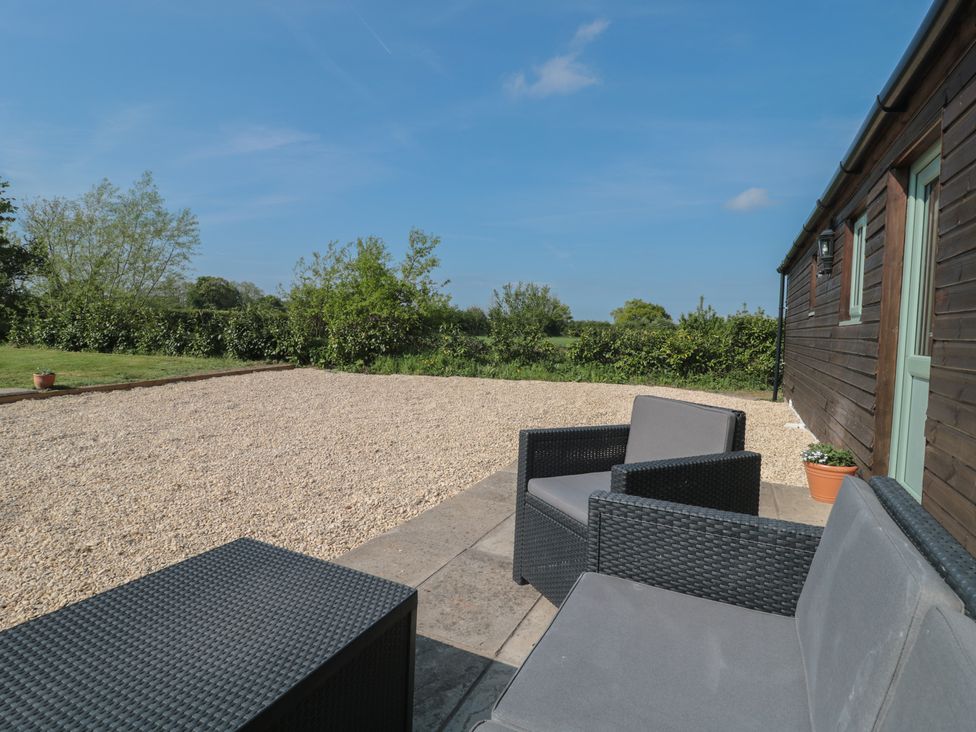 An outdoor seating area with a gravel surface at Garden Cottage, Rode Farm in Rode