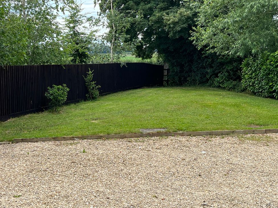 A garden with grass and gravel at Garden Cottage, Rode Farm Rode