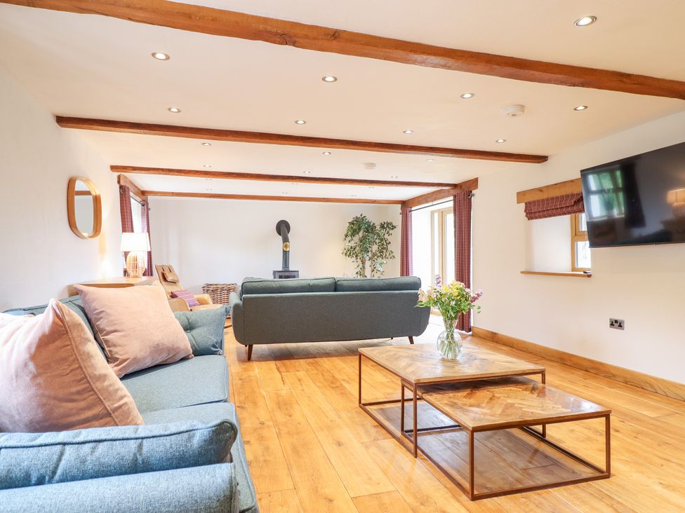 A living room with sofas and a coffee table at Ty Gwyn in Llangwm near Bala