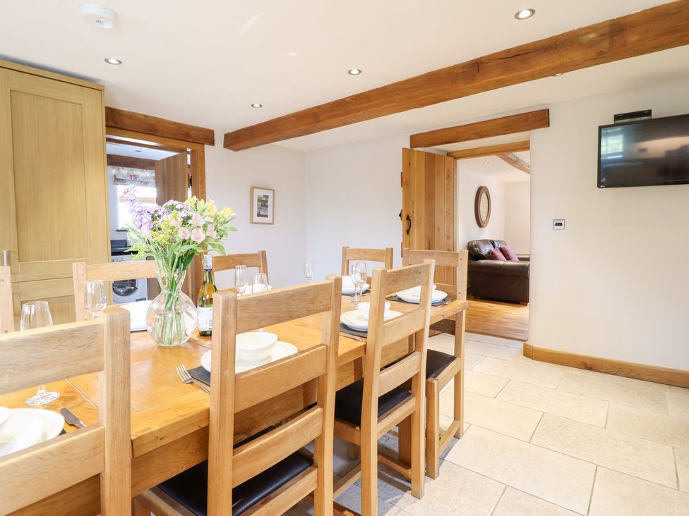 A dining room with a table set for dinner at Ty Gwyn in Llangwm near Bala