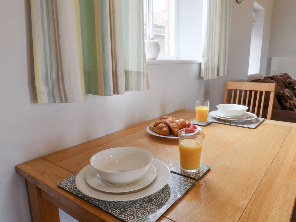 A dining room with a table set for breakfast at Beacon in Gerrick near Moorsholm