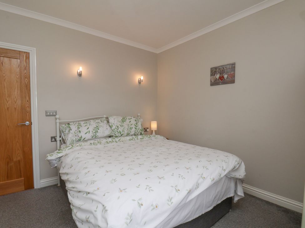 A bedroom with a bed and bedside lamp at Beacon in Gerrick near Moorsholm
