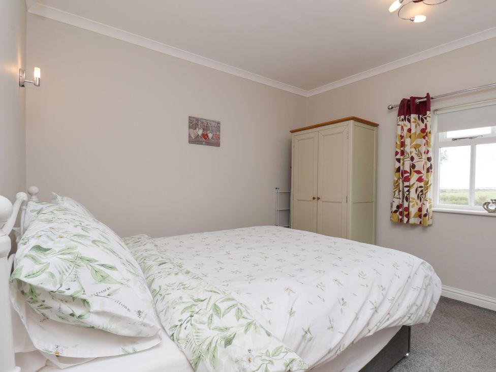 A bedroom with a bed and wardrobe at Beacon in Gerrick near Moorsholm