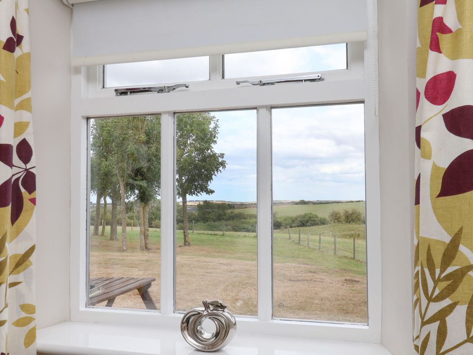 A window with a view of trees and a field at Beacon in Gerrick near Moorsholm