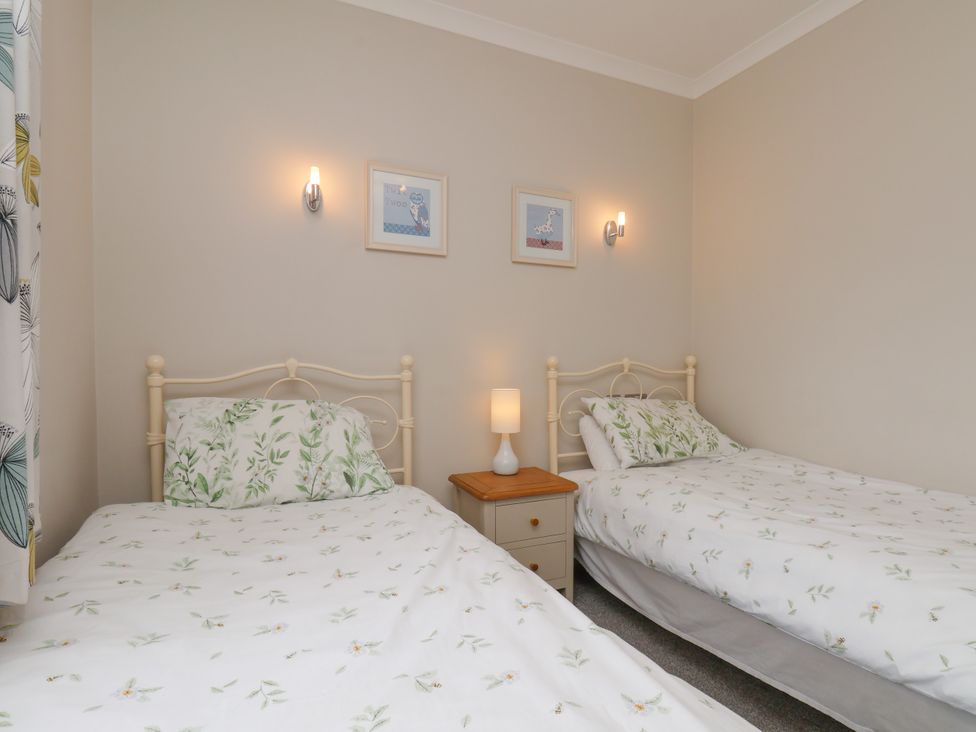 A bedroom with two beds and a nightstand at Beacon in Gerrick near Moorsholm