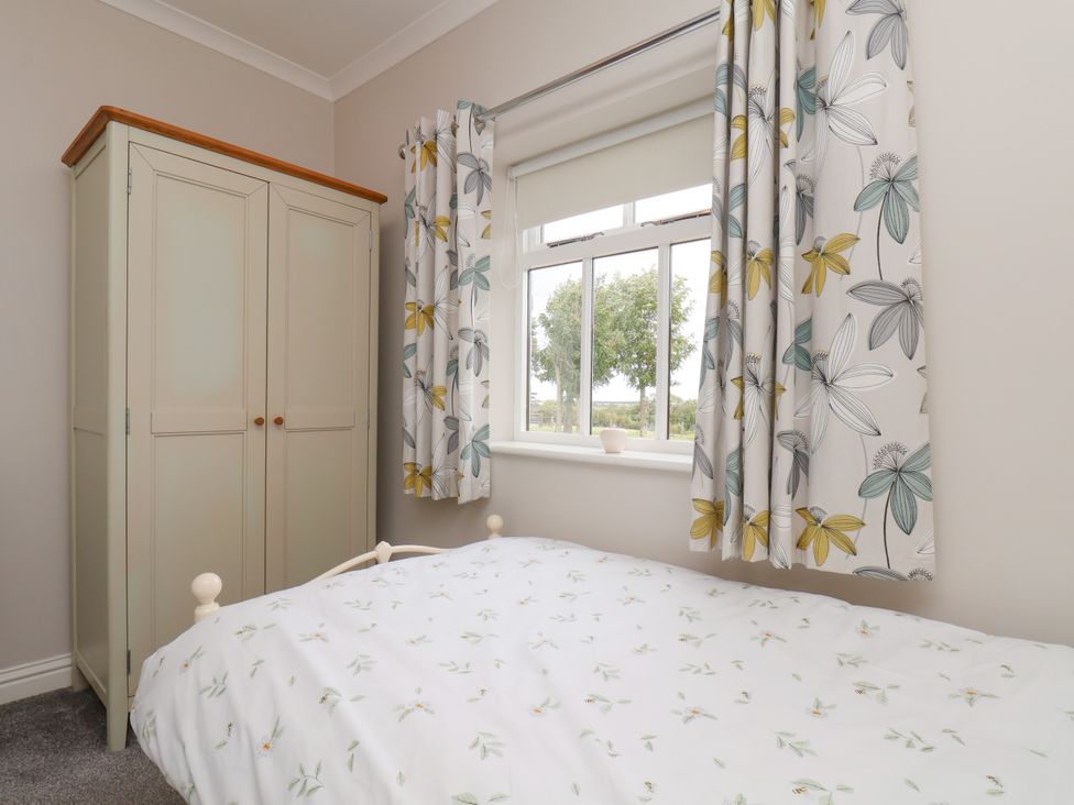 A bedroom with a bed and wardrobe at Beacon in Gerrick near Moorsholm